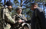 Afghan National Defense Security Forces role players talk to Capt. Justin Alexander, a combat team advisor team leader assigned to the 1st Security Force Assistance Brigade during a simulated event at the Joint Readiness Training Center at Fort Polk, La., Jan. 13, 2018. The JRTC rotation was conducted in order to prepare the newly formed 1st SFAB for an upcoming deployment to Afghanistan in the spring of 2018. SFAB’s provide combat advising capability while enabling brigade combat teams to prepare for decisive action, improving readiness of the Army and its partners. (U.S. Army photo by Pfc. Zoe Garbarino/Released)