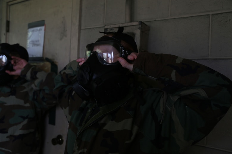 MCAS FUTENMA, OKINAWA, Japan – A Marine breaks the seal on their gas mask Jan. 11 in the gas chamber on Marine Corps Air Station Futenma, Okinawa, Japan.