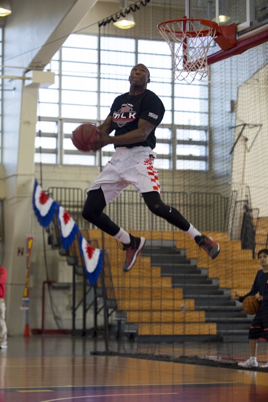 Spc. Isaiah Redfearn dunks the ball during the dunk contest at the Annual Martin Luther King Basketball Tournament Jan. 13 aboard Camp Foster, Okinawa, Japan. The dunk contest was one of the three skills competitions players were able to participate in during the tournament. Redfearn is an information technology specialist with 1st Battalion, 1st Air Defense Artillery Regiment. (U.S. Marine Corps photo by Pfc. Nicole Rogge)