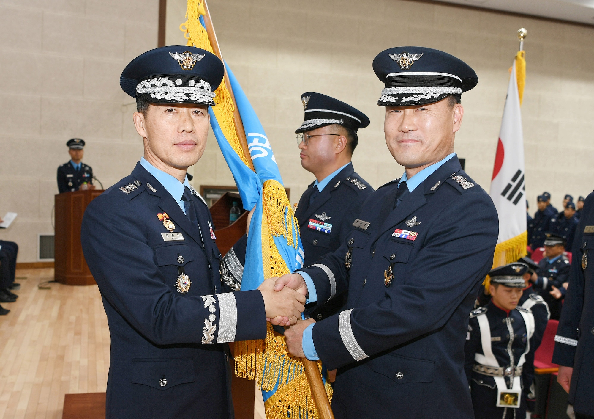 Republic of Korea Maj. Gen. Jun-sik Kim, Air Combat Command commander, shakes the hand of Col. Jae-Gyun Jeon, 38th Fighter Group commander “Thor”, during the change of command ceremony at Kunsan Air Base, RoK, Jan. 17, 2018.  Similar to the U.S. military tradition, the Korean change of command ceremony represents a formal transfer of authority and responsibility. (Courtesy photo)