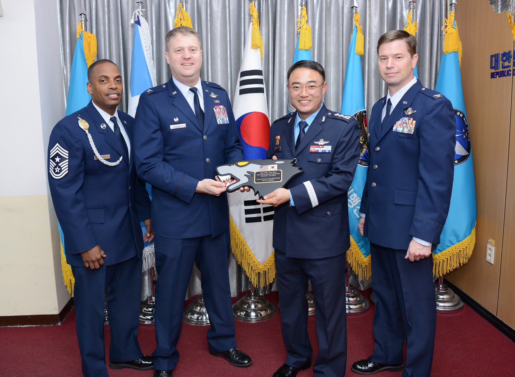 U.S. Air Force Col. David Shoemaker, 8th Fighter Wing commander, presents Republic of Korea Col. Jun-sun Cha, outgoing 38th Fighter Group commander “Thor”, with a parting gift following the change of command ceremony at Kunsan Air Base, RoK, Jan. 17, 2018.  Cha recognized the 8th FW in his farewell speech noting that “we are one team,” and the partnership between the two groups is something he will remember most. (Courtesy photo)