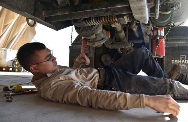 U.S. Air Force Senior Airman James Hajek, 407th Expeditionary Logistics Readiness Squadron Vehicle Management firetruck and refueling maintenance journeyman, works on a fuel truck at the 407th Air Expeditionary Group in Southwest Asia, Dec. 18, 2017. Hajek ensures the multi-axle vehicles stay operational. (U.S. Air Force photo by Staff Sgt. Joshua Edwards/Released)