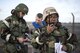 Members of the 48th Fighter Wing conduct unexploded ordnance training during an Ability to Survive and Operate exercise at Royal Air Force Lakenheath, England, Jan. 16. The training involved donning protective gear and reacting to simulated threats, applying self-aid and buddy care, sheltering-in-place and clearing areas of unexploded ordnance.  (U.S. Air Force photo/Senior Airman Malcolm Mayfield)