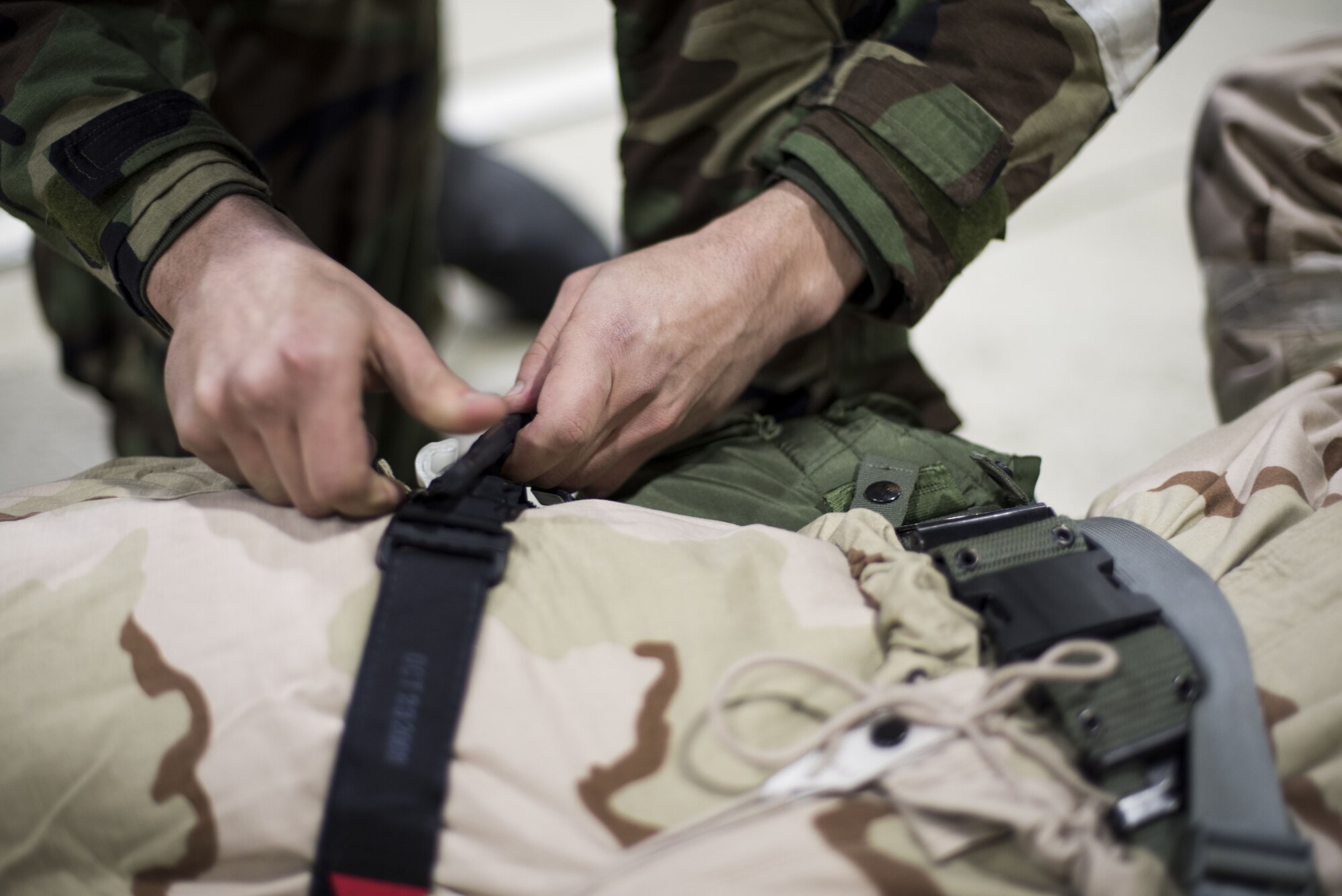 A Member of the 48th Fighter Wing practices self-aid and buddy care during an Ability to Survive and Operate exercise at Royal Air Force Lakenheath, England, Jan. 16. The two-day exercise was aligned with Air Force efforts to reinvigorate ATSO and chemical, biological, radiological and nuclear defense type training, focusing on preparedness and operating in contested environments. (U.S. Air Force photo/Senior Airman Malcolm Mayfield)