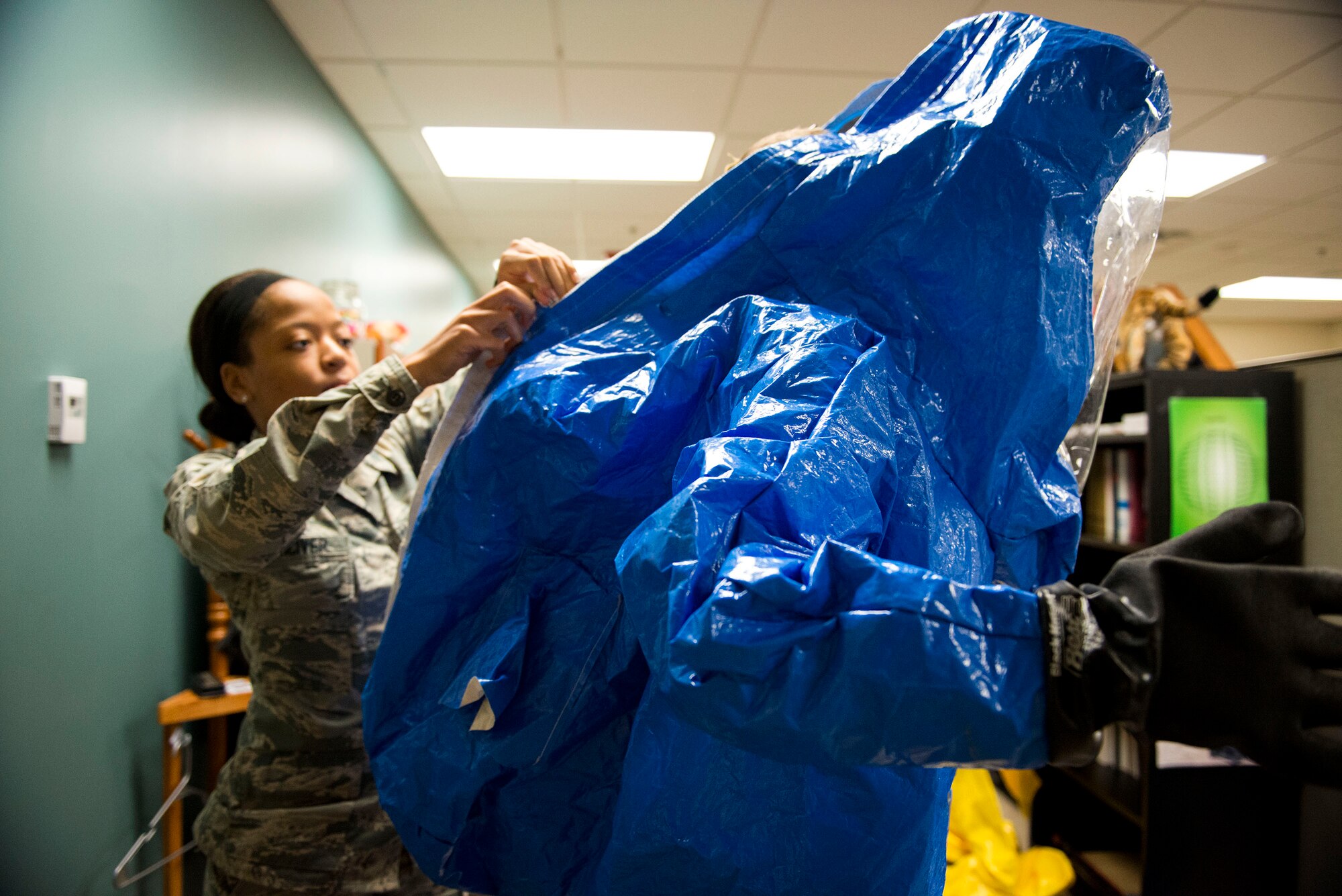 Airman 1st Class Briana McIver, left, 23d Aerospace Medicine Squadron (AMDS) bioenvironmental engineering apprentice, secures 2nd Lt. Eric Olson, 23d AMDS bioenvironmental engineer, in a Level A suit during readiness training, Jan. 12, 2018, at Moody Air Force Base, Ga. A Level A suit is designed to protect the user against any biological threat. The Bioenvironmental Engineering Flight tested their response capabilities in a simulated contamination scenario. Bioenvironmental engineering specialists focus on reducing health hazards in the workplace and surrounding areas. (U.S. Air Force photo by Airman 1st Class Erick Requadt)