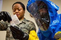 Airman 1st Class Briana McIver, left, 23d Aerospace Medicine Squadron (AMDS) bioenvironmental engineering apprentice, and 2nd Lt. Eric Olson, 23d AMDS bioenvironmental engineer, read instructions for a hand held assay (HHA) during biohazard readiness training, Jan. 12, 2018, at Moody Air Force Base, Ga. A HHA distinguishes whether or not the sample is a deadly protein. This process of going through the instructions ensures standardization of sampling. The Bioenvironmental Engineering Flight tested their response capabilities in a simulated contamination scenario. Bioenvironmental engineering specialists focus on reducing health hazards in the workplace and surrounding areas. (U.S. Air Force photo by Airman 1st Class Erick Requadt)