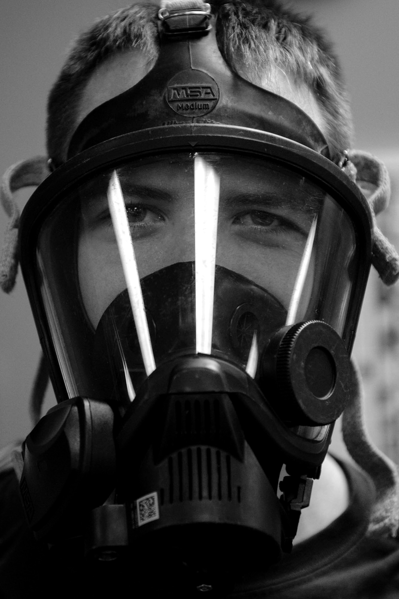 2nd Lt. Eric Olson, 23d Aerospace Medicine Squadron bioenvironmental engineer, gears up during readiness training, Jan. 12, 2018, at Moody Air Force Base, Ga. The Bioenvironmental Engineering Flight tested their response capabilities in a simulated contamination scenario. Bioenvironmental engineering specialists focus on reducing health hazards in the workplace and surrounding areas. (U.S. Air Force photo illustration by Airman 1st Class Erick Requadt)