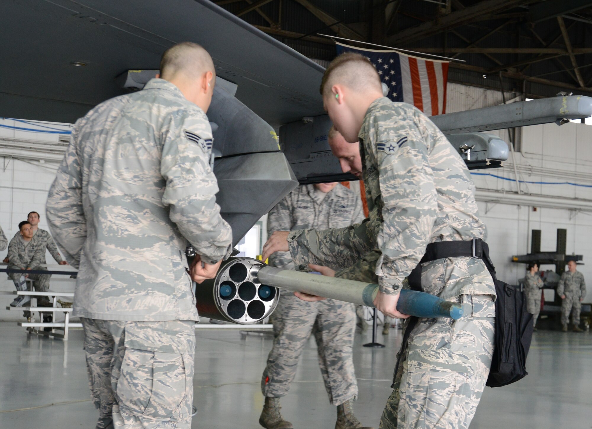 U.S. Airmen assigned to the 20th Aircraft Maintenance Squadron, 55th Aircraft Maintenance Unit, load an F-16CM Fighting Falcon rocket pod with training munitions during the Load Crew of the Quarter competition at Shaw Air Force Base, S.C., Jan. 12, 2018.