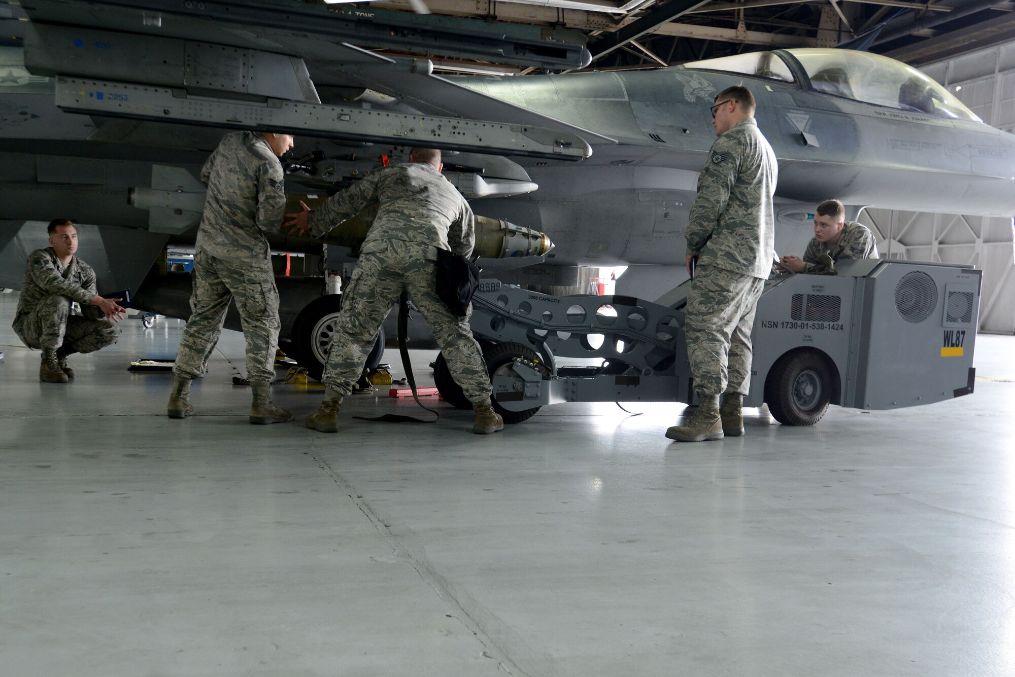 U.S. Airmen assigned to the 20th Aircraft Maintenance Squadron, 55th Maintenance Unit, load a GBU-38 Joint Direct Attack Munition during the Load Crew of the Quarter competition at Shaw Air Force Base, S.C., Jan. 12, 2018.