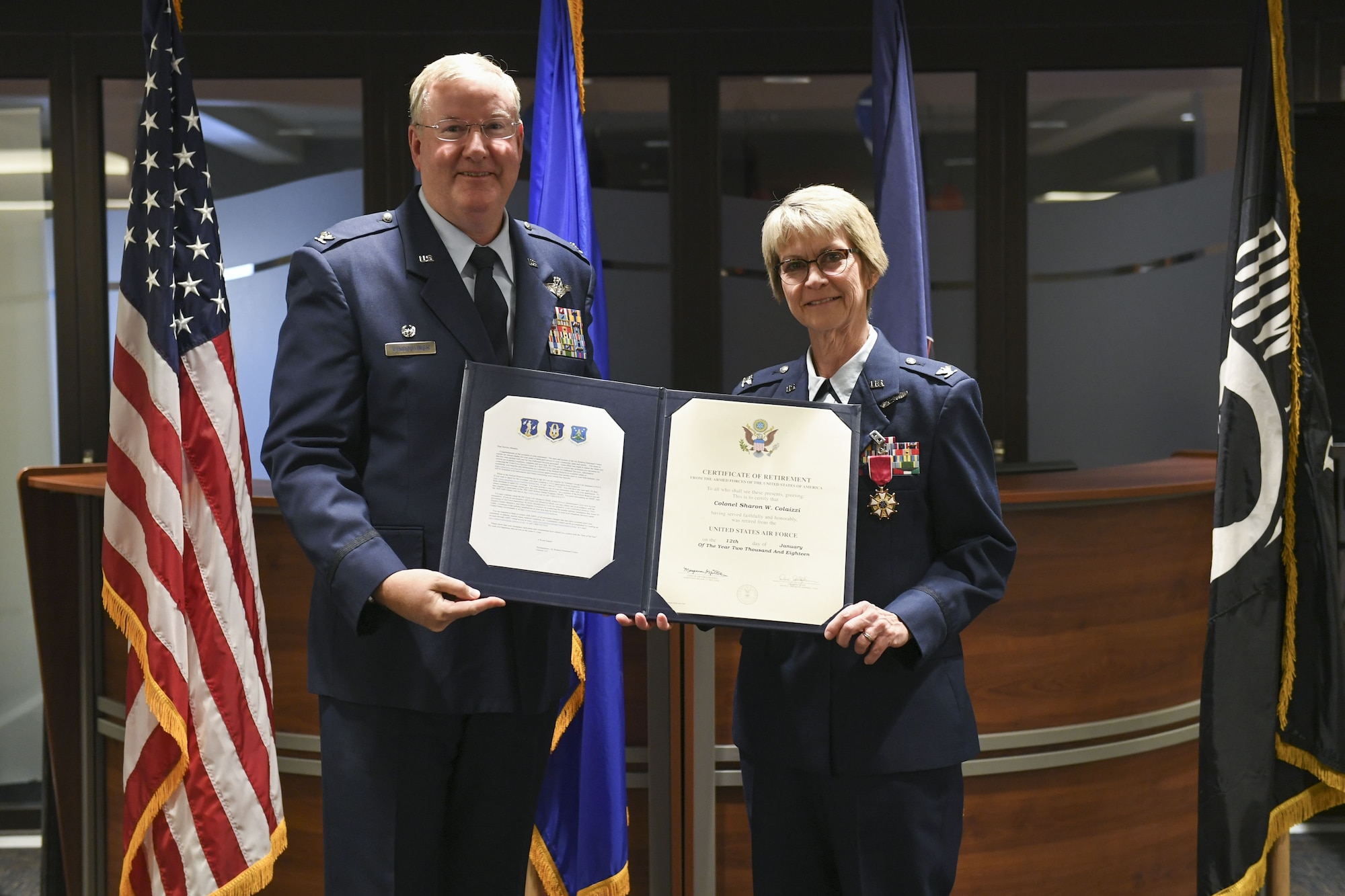Col. Sharon Colaizzi, commander of the 911th Aeromedical Staging Squadron, receives her certificate of retirement from Col. Jeffrey A. VanDootingh, commander of the 911th Airlift Wing at the Pittsburgh International Airport Air Reserve Station, Pa., Jan. 6, 2018. Colaizzi served for 35 years, approximately  34 of which were with the 911th ASTS. (U.S. Air Force photo by Senior Airman Beth Kobily)