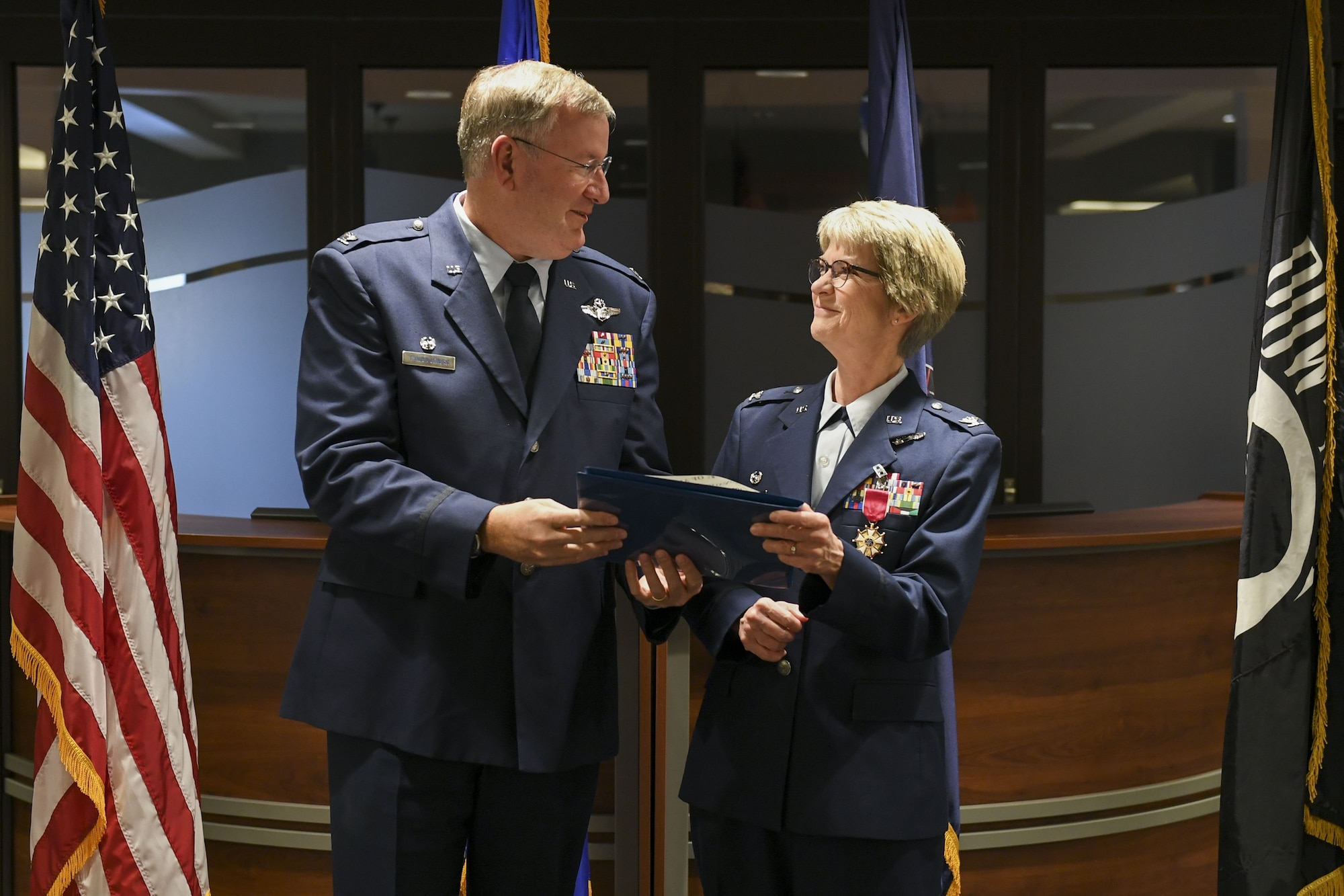 Col. Sharon Colaizzi, commander of the 911th Aeromedical Staging Squadron, receives her certificate of retirement from Col. Jeffrey A. VanDootingh, commander of the 911th Airlift Wing, at the Pittsburgh International Airport Air Reserve Station, Pa., Jan. 6, 2018. Colaizzi served for 35 years, approximately 34 of which were with the 911th ASTS. (U.S. Air Force photo by Senior Airman Beth Kobily)