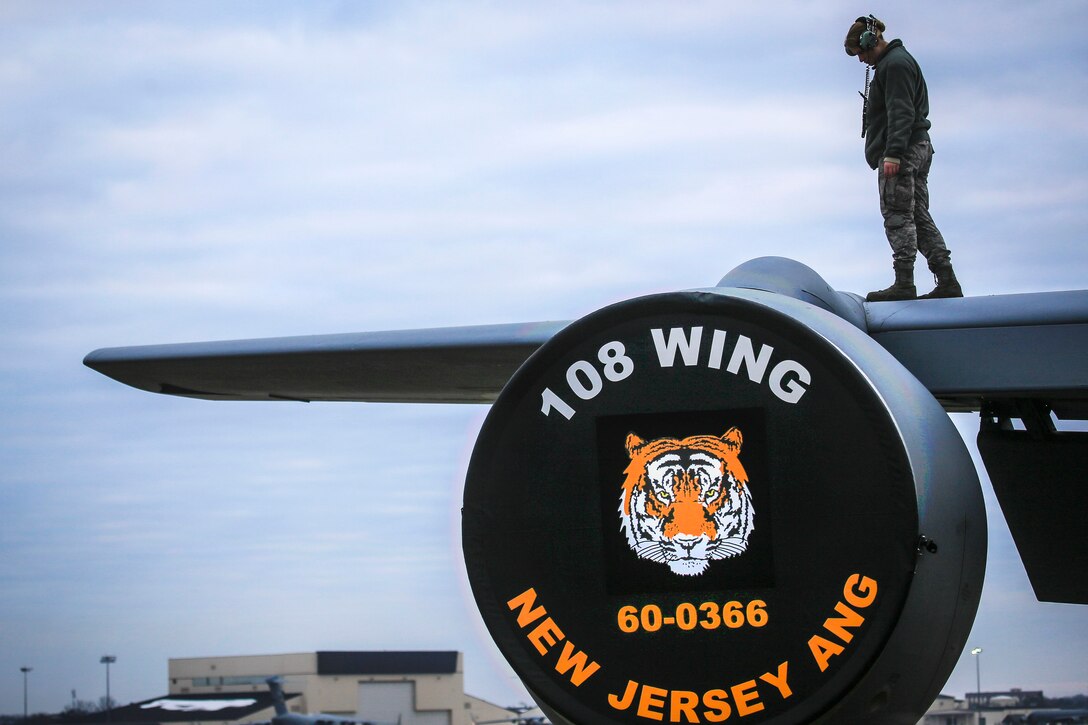 A Guardsman checks a KC-135R Stratotanker wings for imperfections before a flight.