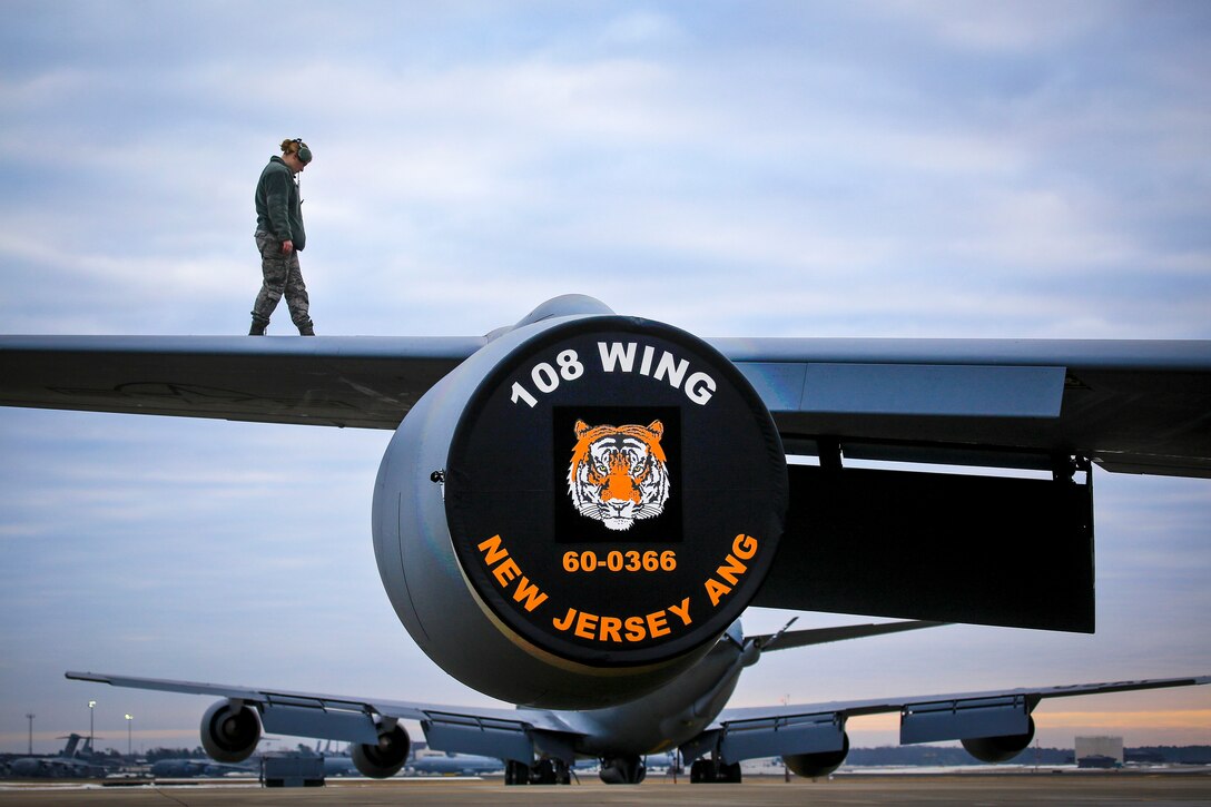 A New Jersey Air National Guardsman checks a KC-135R Stratotanker wings for imperfections before a flight.