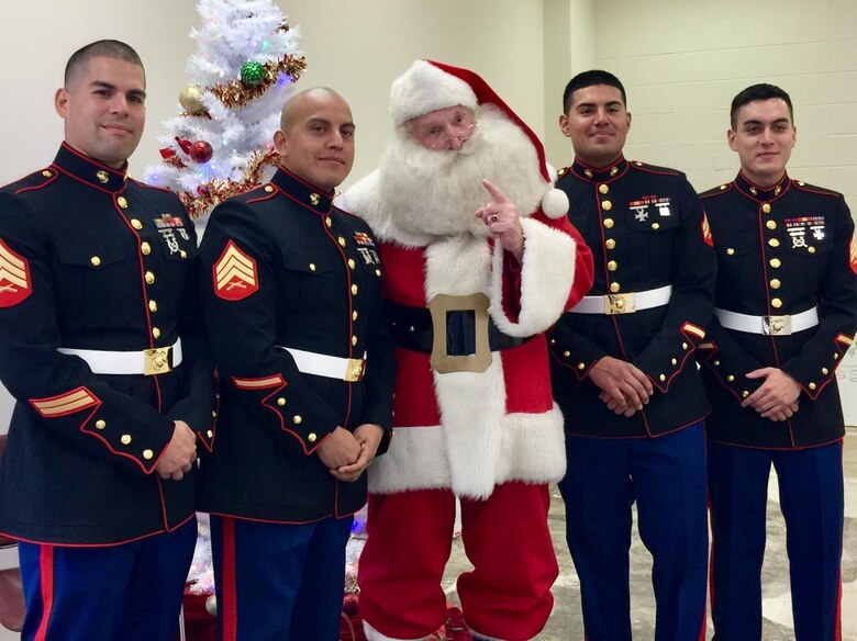 Pictured from left to right are Sgt. Sanchez, Sgt. Diaz-Rodriquez, Cpl. Rodriguez and Sgt. West standing with Santa at the Toys for Tots regional warehouse located in Fredericksburg, Virginia.