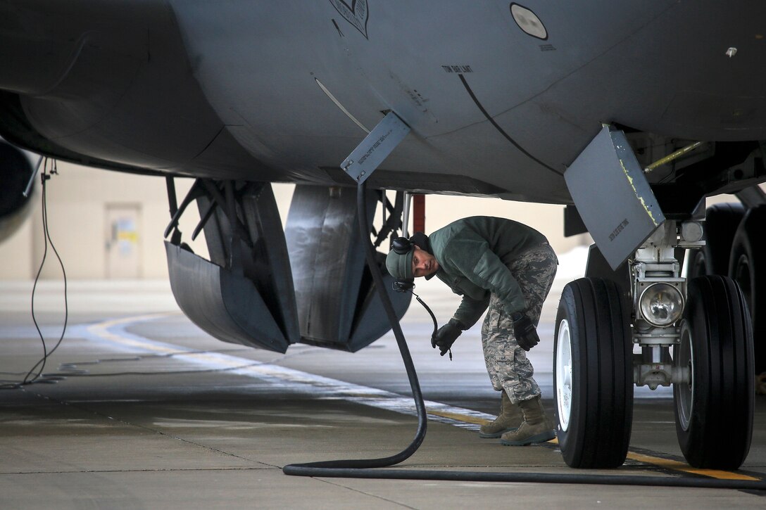 Staff Sgt. Robert Cento performs pre-flight checks on a KC-135R Stratotanker before a training flight.