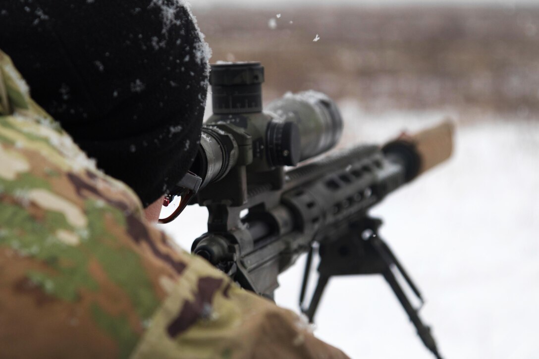 A soldier prepares to fire an M2010 rifle after acquiring his target.