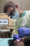 Dr. Jake Williams, Veterans Affairs dentist, inspects his patient’s teeth January 9, 2017, at Joint Base San Antonio-Randolph.  Williams is the first Veterans Affairs dentist to be assigned to the new office located at the 359th Medical Squadron on JBSA-Randolph.  (U.S. Air Force photo by Sean M. Worrell)