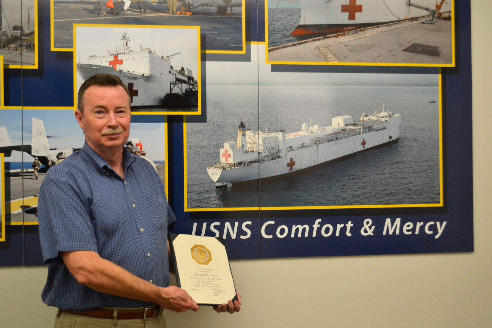 Randall Owens poses with his certificate recognizing his 40 years of federal service.
