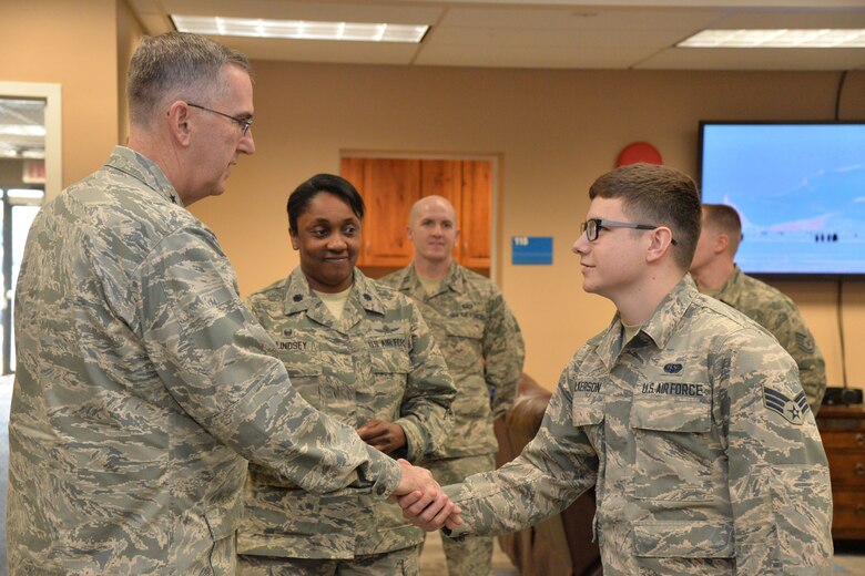 U.S. Air Force Gen. John Hyten, commander of U.S. Strategic Command (USSTRATCOM); shakes hands with Senior Airman Landon Wilkerson, 341st Communications Squadron, at the Malmstrom Air Force Base resiliency center in Montana, Jan. 16, 2018.