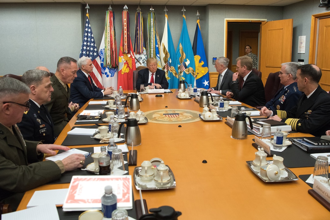 President Donald J. Trump speaks with Defense Secretary James N. Mattis and Pentagon senior leader while seated around a long table.