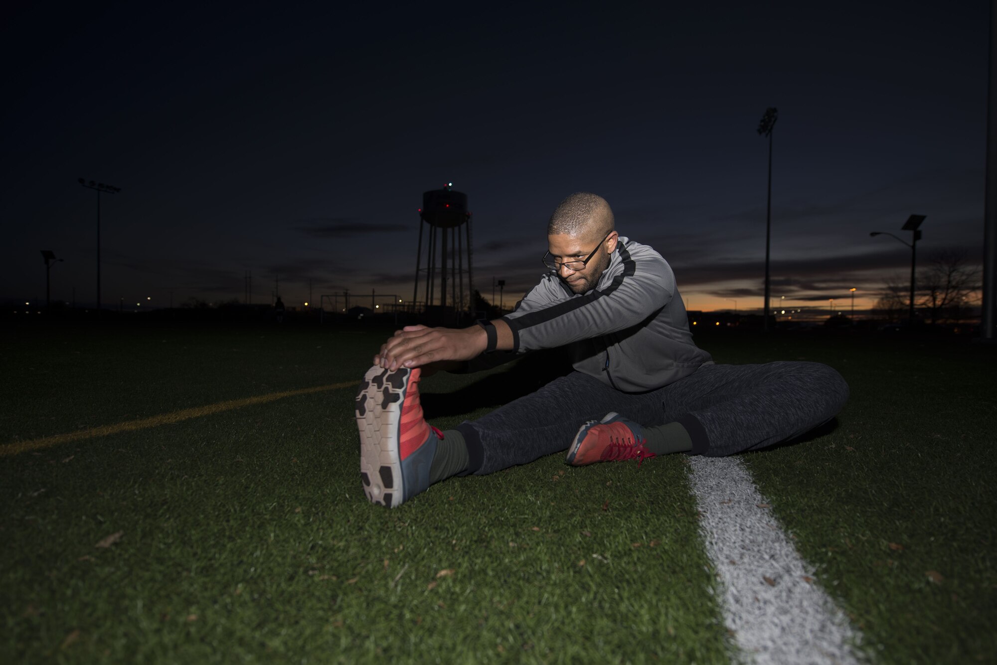 Senior Airman Joseph Amador, 366th Fighter Wing judge advocate military justice paralegal, stretches his hamstring for the Slimpossible challenge Jan. 12, 2018, at the Gunfighter Fitness Center, Mountain Home Air Force Base, Idaho. Amador performed leg stretches to cool down from his run. (U.S. Air Force photo by Airman 1st Class JaNae Capuno)
