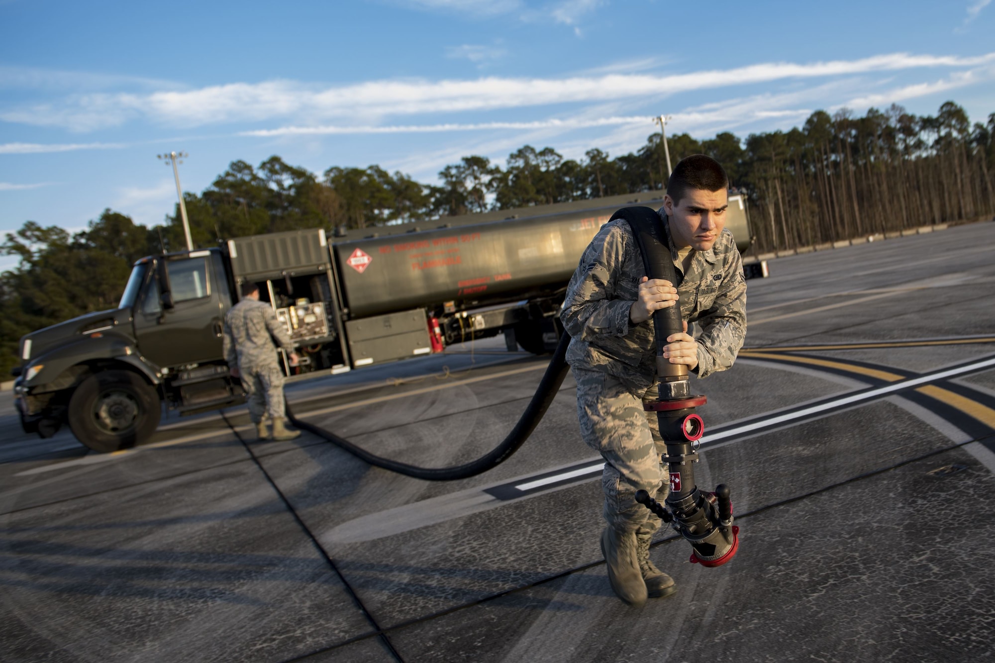 Airman 1st Class Evan Valance, 23d Logistics Readiness Squadron fuels distribution operator, drags a fuel hose away from an M-11 refueling truck to conduct HH-60G Pave Hawk hot-pit refueling operations, Jan. 16, 2018 at Moody Air Force Base, Ga. Airmen who work in the petroleum, oils and lubricants (POL) flight frequently use hot pit refueling, which is a more efficient tactic that allows aircrews a quick transition from the flight line back to their current objective. (U.S. Air Force photo by Senior Airman Daniel Snider)