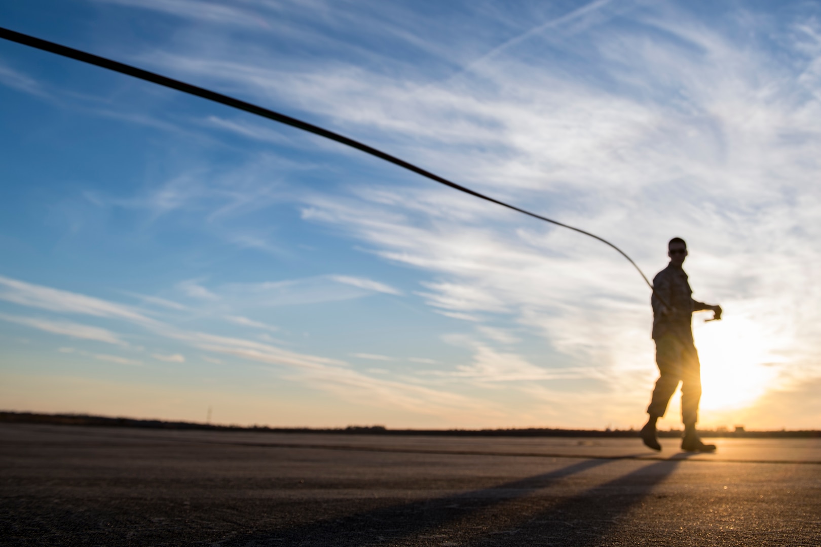 Airman 1st Class Evan Valance, 23d Logistics Readiness Squadron fuels distribution operator, drags a trigger hose away from a M-11 refueling truck to conduct HH-60G Pave Hawk hot-pit refueling operations, Jan. 16, 2018 at Moody Air Force Base, Ga. Airmen who work in the petroleum, oils and lubricants (POL) flight frequently use hot pit refueling, which is a more efficient tactic that allows aircrews a quick transition from the flight line back to their current objective. (U.S. Air Force photo by Senior Airman Daniel Snider)