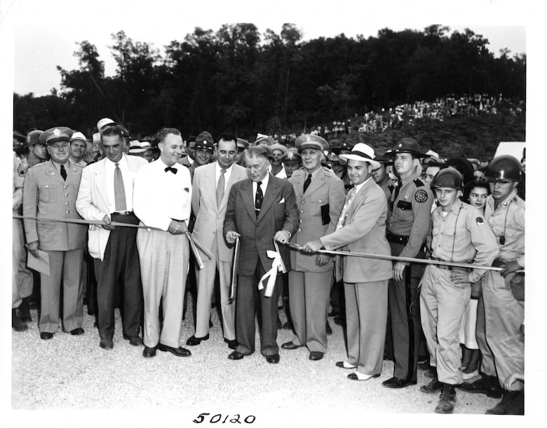 Vice President Alben W. Barkley cuts the ribbon to dedicate Wolf Creek Dam in Jamestown, Ky., Sept. 1, 1951.  Lt. Gen. Lewis A. Pick, U.S. Army Corps of Engineers commander, is standing to the right of the vice president. The U.S. Army Corps of Engineers Nashville District constructed the dam on the Cumberland River, which formed Lake Cumberland. (USACE Photo)