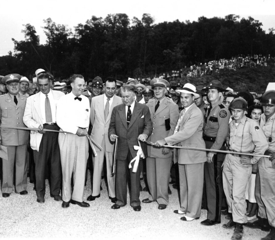 Vice President Alben W. Barkley cuts the ribbon to dedicate Wolf Creek Dam in Jamestown, Ky., Sept. 1, 1951.  Lt. Gen. Lewis A. Pick, U.S. Army Corps of Engineers commander, is standing to the right of the vice president. The U.S. Army Corps of Engineers Nashville District constructed the dam on the Cumberland River, which formed Lake Cumberland. (USACE Photo)