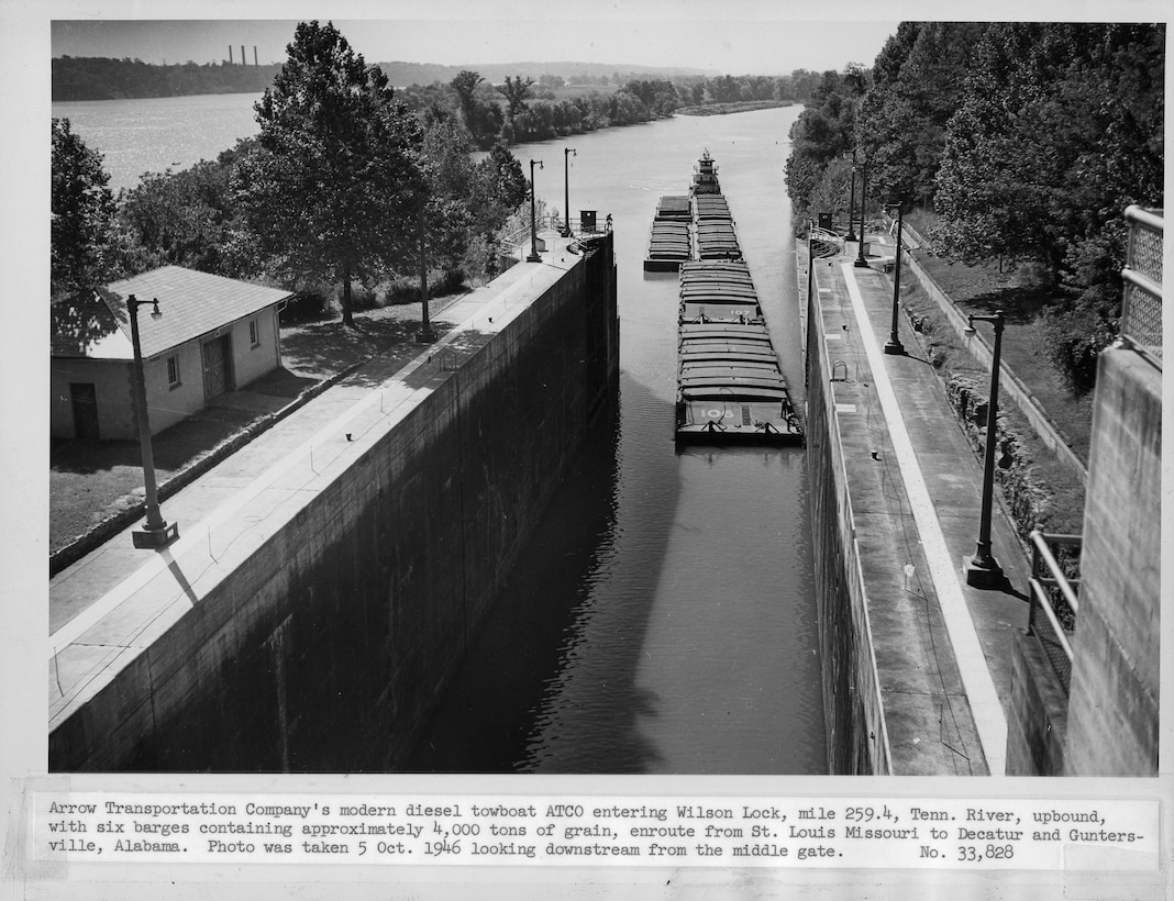 Arrow Transportation Company's diesel towboat ATCO enters Wilson Lock Oct. 5, 1946 at Tennessee River mile 259.4 in Florence, Ala.  The six bargers contained approximately 4,000 tons of grain from St. Louis, Mo., headed to Decatur and Guntersville, Ala. The U.S. Army Corps of Engineers Nashville District operate and maintain the lock at the Tennessee Valley Authority project. (USACE Photo)