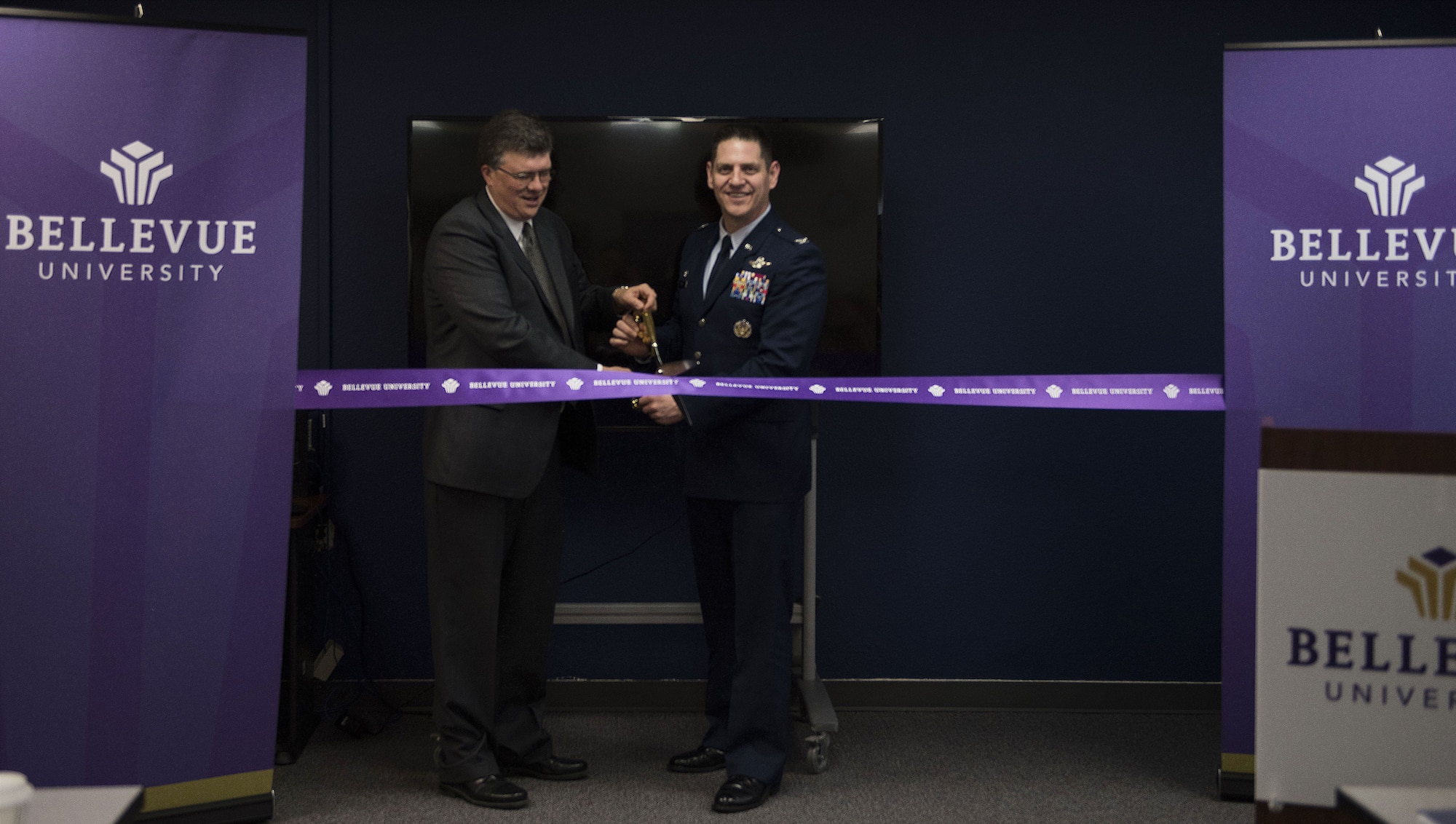 Jim Grotrian, Bellevue University vice president of strategic partnerships, and Col. Joe Kunkel, 366th Fighter Wing commander, participate in a ribbon cutting ceremony for the opening of Bellevue University at the education center Jan. 18, 2018, at Mountain Home Air Force Base, Idaho. Bellevue University is the forth college to offer services at the education center here. (U.S. Air Force photo by Airman 1st Class Alaysia Berry)