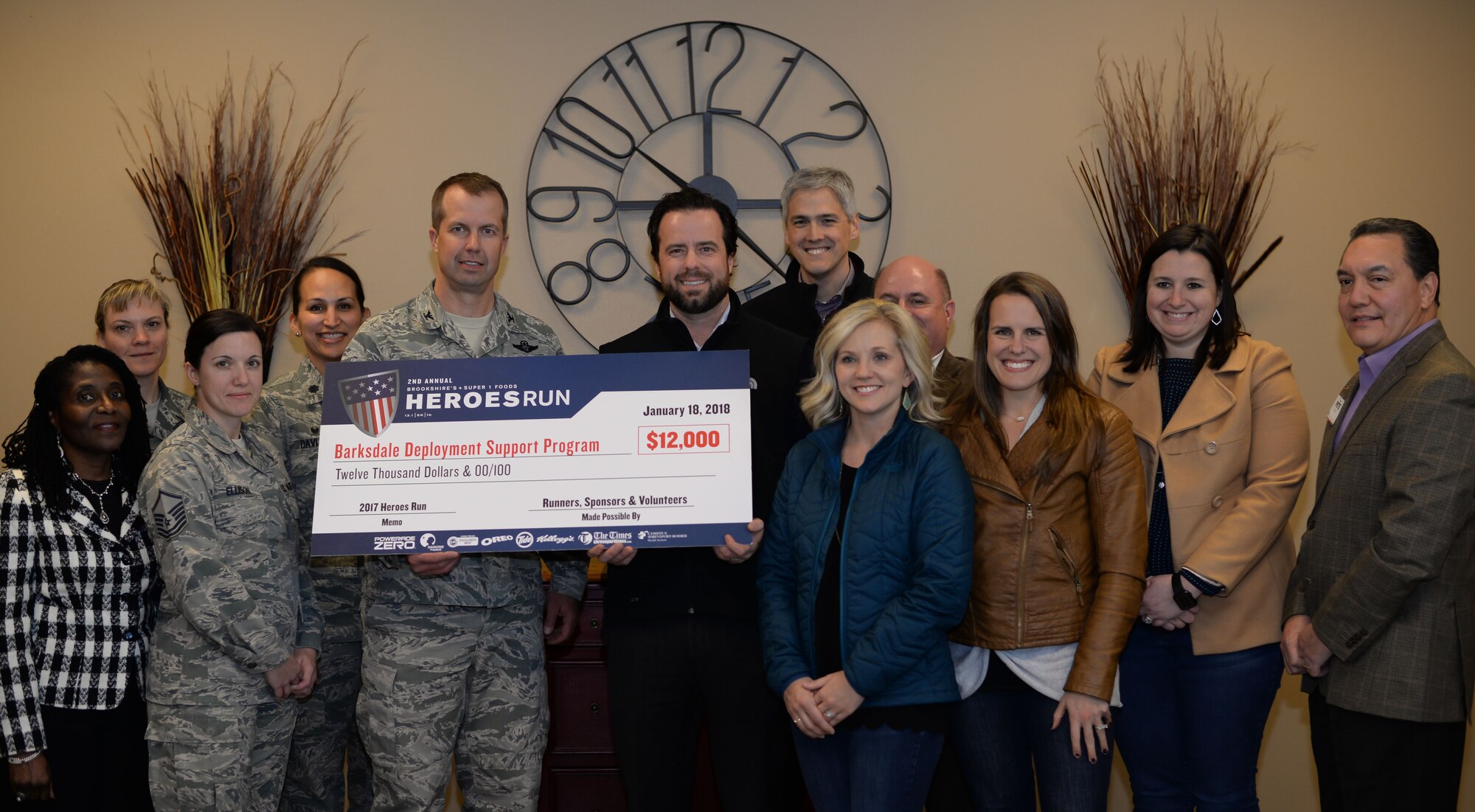 Members of the 2nd Bomb Wing and Brookshire’s Grocery Company pose for a photo with a $12,000 check at Barksdale Air Force Base, La., Jan. 18, 2018.
