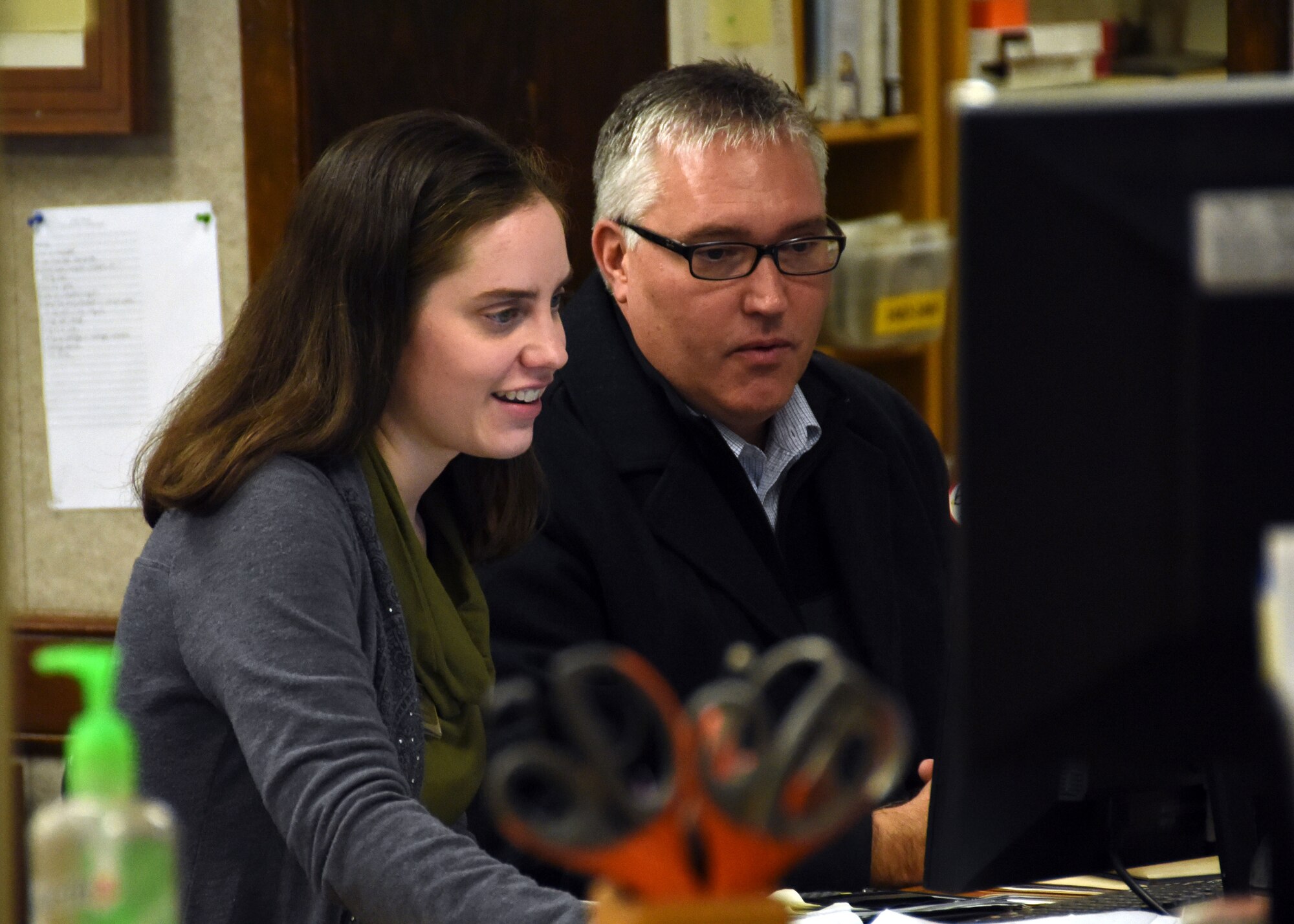 Emily Copeland, 325th Force Support Squadron’s new librarian, and Mark Rix, 325th Force Support Squadron Force Development flight chief, process data on Copeland’s computer at Tyndall Air Force Base, Fla., Jan. 18, 2018. As the new librarian, Copeland will wear many hats: facility manager, resource manager, information technology equipment custodian and activities director. The Tyndall library supports the community by providing education, reference and reading materials for Airmen and family members of all ages. (U.S. Air Force photo by Airman 1st Class Isaiah J. Soliz/Released)