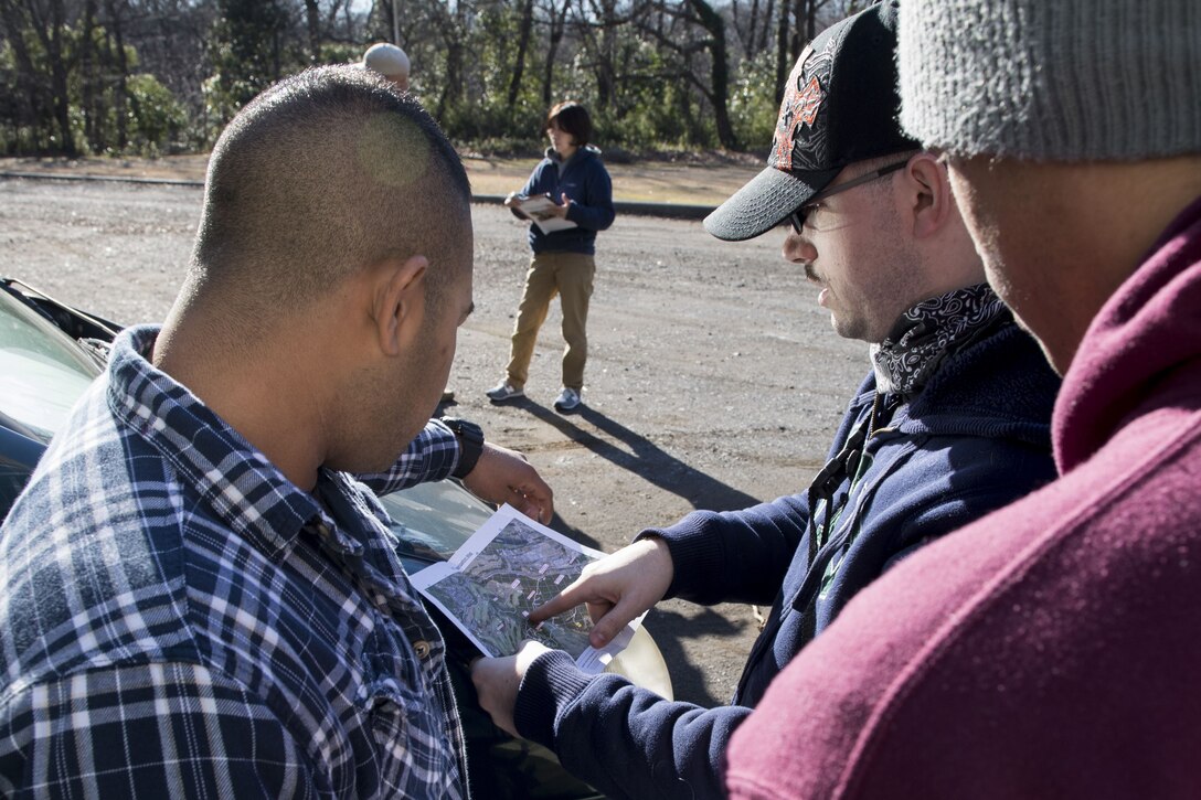 Airmen with the 374th Security Forces Squadron decide where they are going to start their search during regular military working dog human detection training, Jan. 11, 2018, at Tama Hills Recreation Area, Japan.