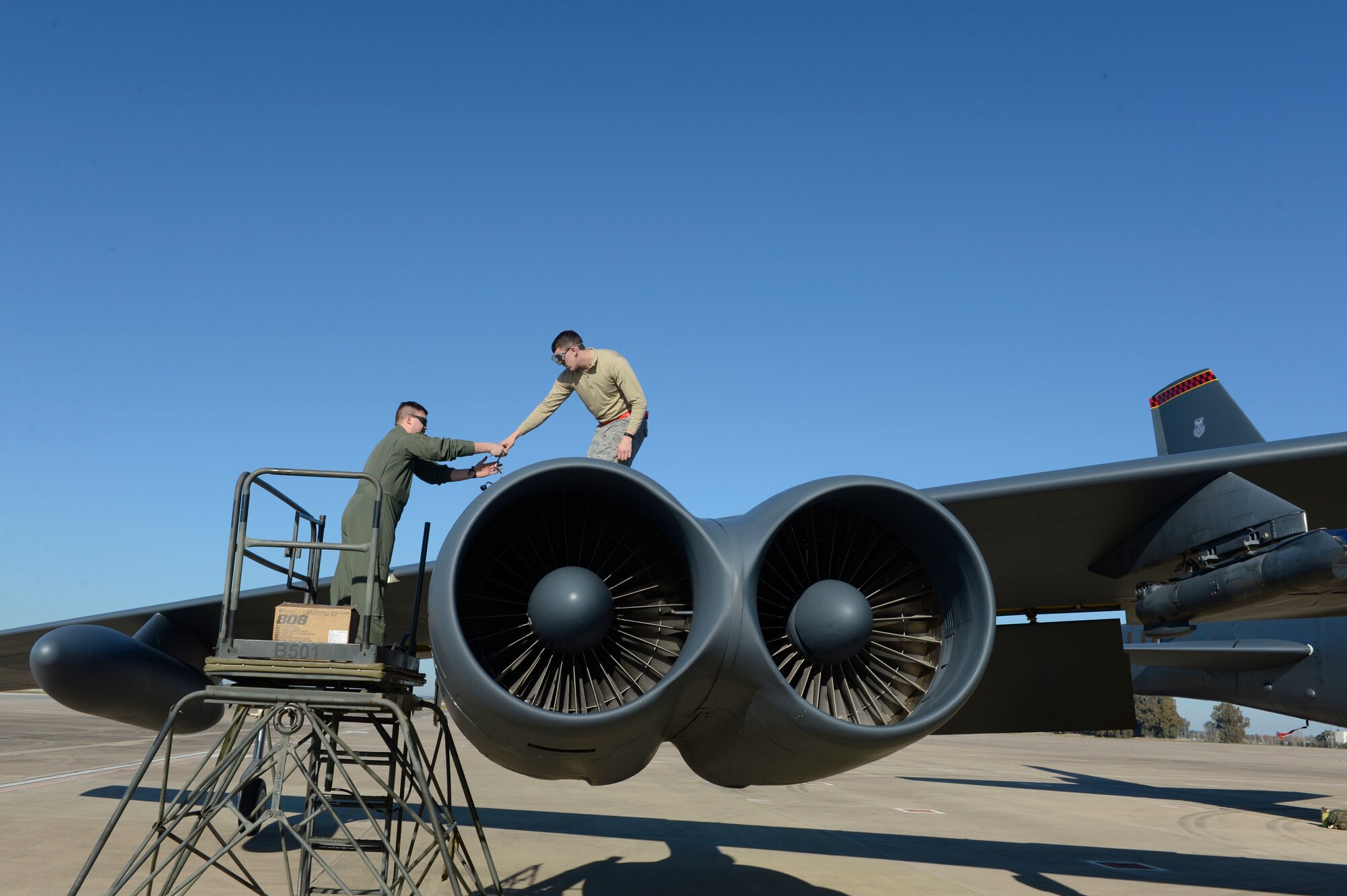 A crew member and maintainer, assigned to the 23rd Expeditionary Bomb Squadron, perform flight inspections on a B-52 Stratofortress, at Morón Air Base, Spain, Jan. 16, 2018. The deployment of four B-52s to Europe helps exercise United States Air Forces in Europe's forward operating location for bombers. (U.S. Air Force photo by Senior Airman Natalie Plas)