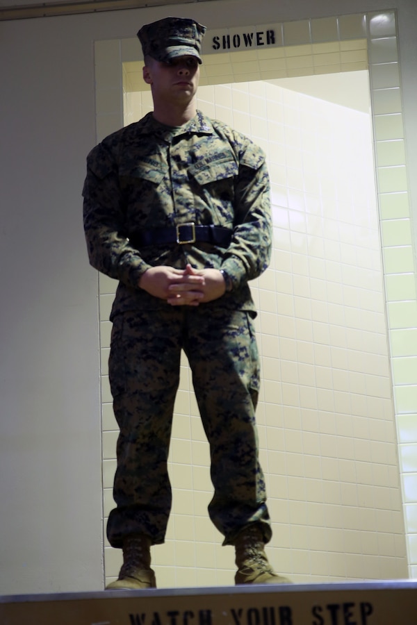 CAMP HANSEN, OKINAWA, Japan – Sgt. Dustin Owens observes awardees during a Correctional Custody Unit demonstration Jan. 12 in the Brig aboard Camp Hansen, Okinawa, Japan. Awardees, Marines assigned to the CCU, will spend seven or 30 days under constant surveillance completing hard labor, formal uniform inspections, combat fitness training and values-based relapse prevention training. Awardees will always be under the supervision of a senior watch stander and assigned watch standers. The Correctional Custody Unit is scheduled to open their doors Feb. 14 at the Brig aboard Camp Hansen, Okinawa, Japan. Owens is a senior watch stander with Headquarters and Support Battalion, Marine Corps Installations Pacific-Marine Corps Base Camp Butler, Japan.