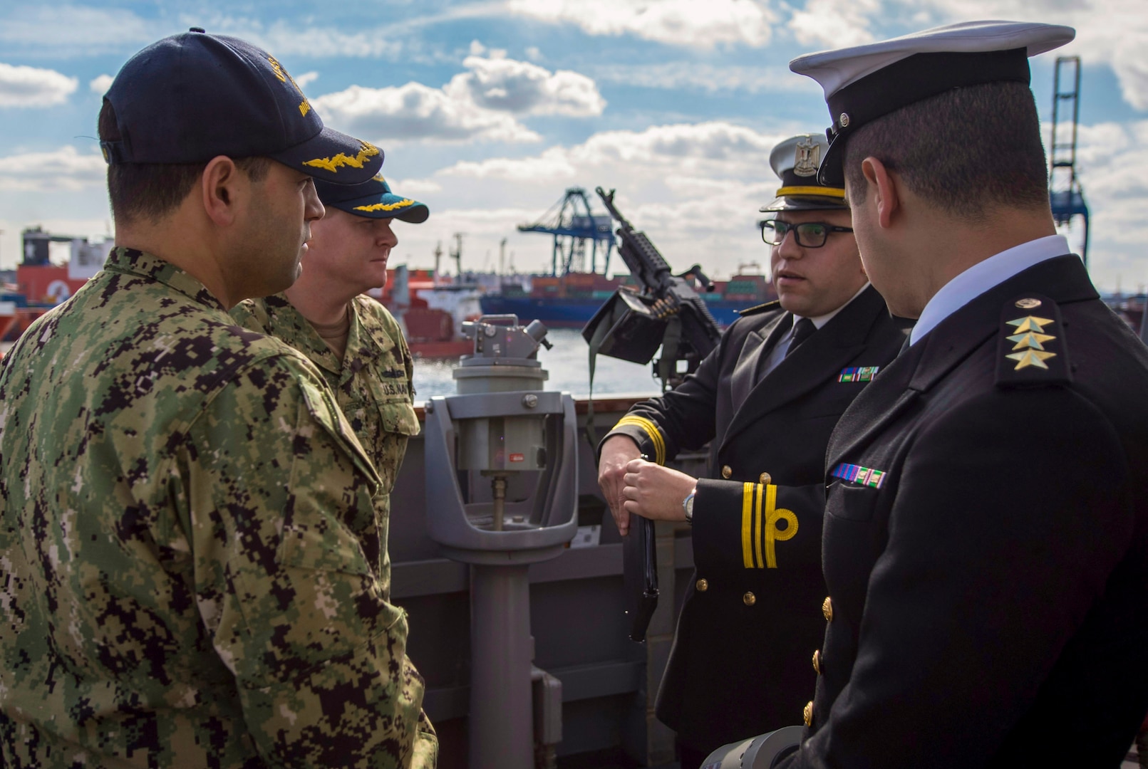 180116-N-KA046-0378 ALEXANDRIA, Egypt (Jan. 16, 2017) Cmdr. Tyson Young, executive officer, left, and Cmdr. Peter Halvorsen, commanding officer of the Arleigh Burke-class guided-missile destroyer USS Carney (DDG 64) speak with Egyptian naval officers on the bridge wing. Carney, forward-deployed to Rota, is on its fourth patrol in the U.S. 5th Fleet area of operations in support of maritime security operations to reassure allies and partners and preserve the freedom of navigation and free flow of commerce in the region. (U.S. Navy photo by Mass Communication Specialist 2nd Class James R. Turner/Released)