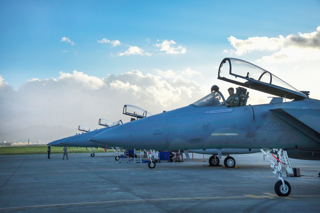 Air Force pilots prepare F-15C Eagle fighter aircraft.