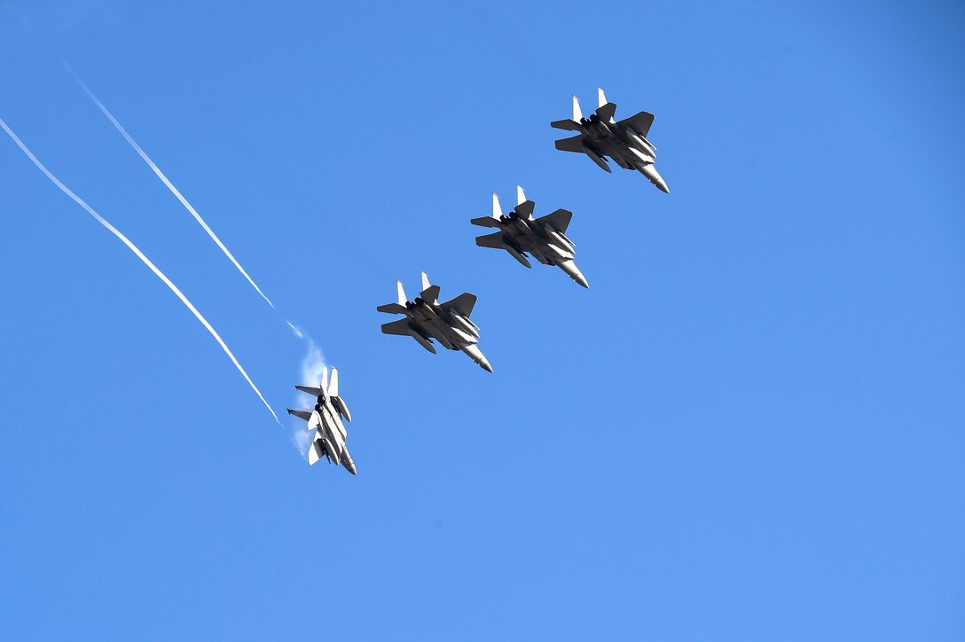 Four Air Force F-15C Eagle fighter aircraft flying in formation.
