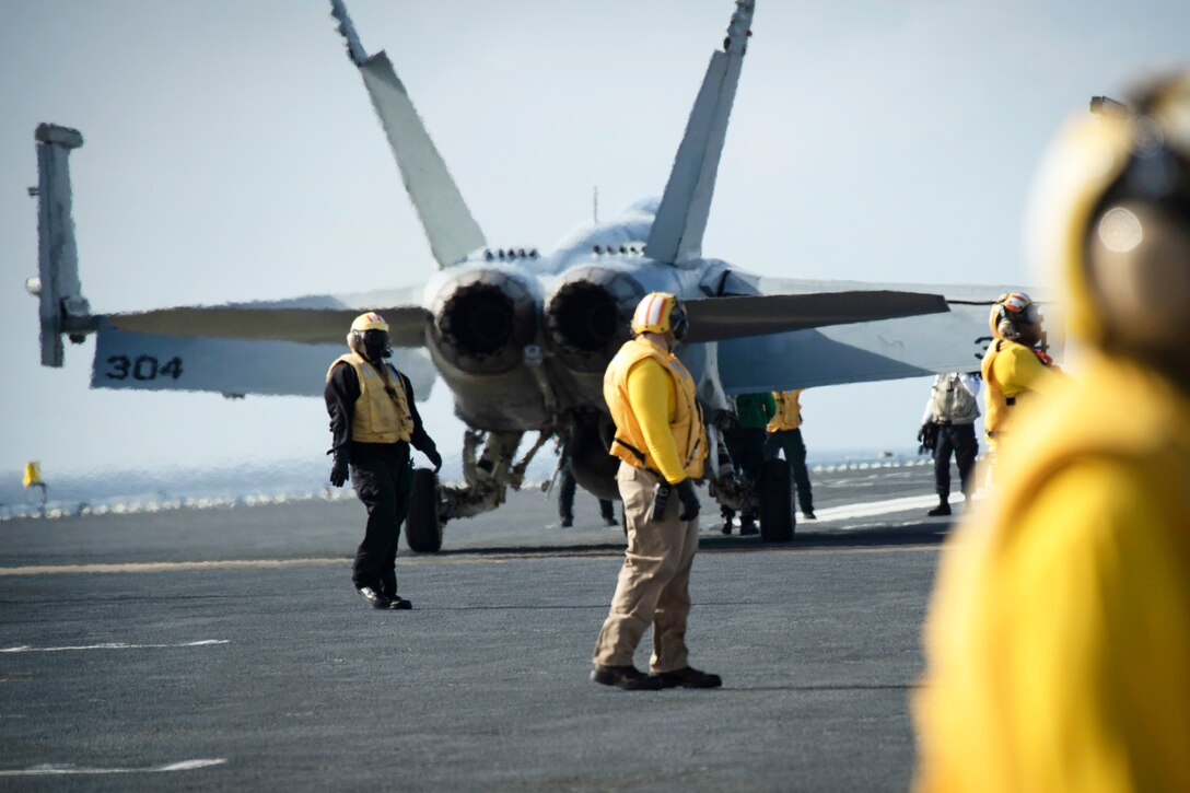 An F/A-18F Super Hornet aircraft approaches a catapult before being launched on the flight deck of the USS Gerald R. Ford.