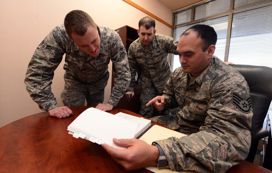 (From left to right) Airmen 1st Class Justin Townsend and Daniel Stilts, contract specialists assigned to the 28th CONS train with Staff Sgt. Tanner Meyer, a contracting officer assigned to the 28th Contracting Squadron, on the contract process at Ellsworth Air Force Base, S.D., Jan. 11, 2018. The 28th CONS is one of the smallest squadron on base, but plays an important role in providing agile contracting support and business advice to those who work at Ellsworth AFB. (U.S. Air Force photo by Airman 1st Class Donald C. Knechtel)