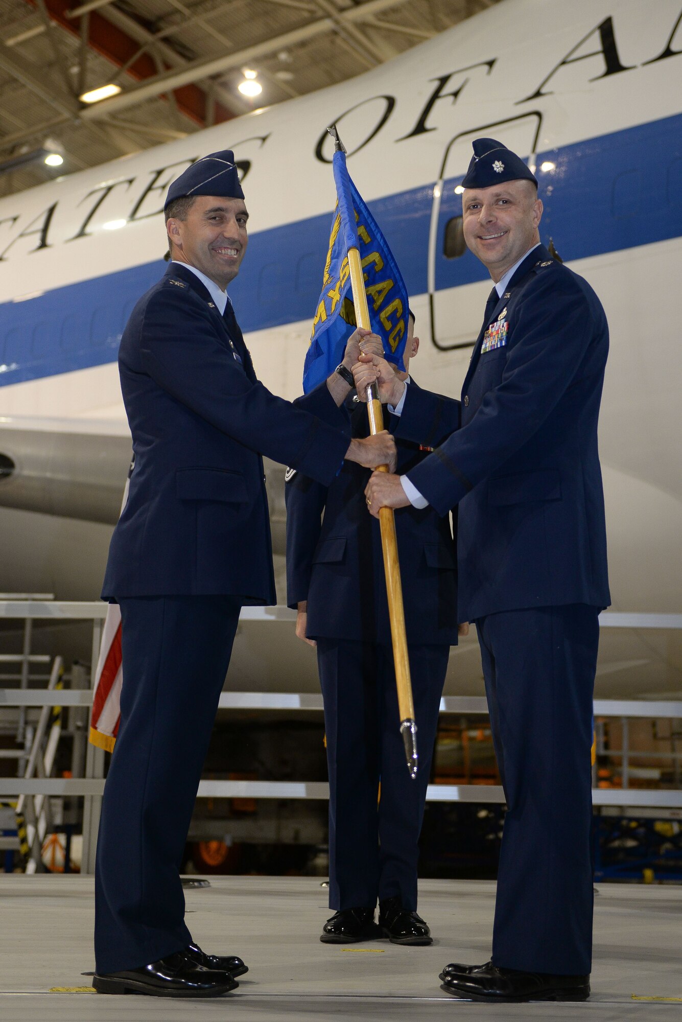 Col. Robert Billings, left, commander of the 595th Command and Control Group, passes the guidon to Lt. Col. Douglas Dodge, right, commander of the 595th Aircraft Maintenance Squadron (AMXS) at the group's activation Oct. 10, 2016. The 595th AMXS was awarded the Air Force Global Strike Command Unit Effectiveness Award Jan. 4, 2018, barely a year after the activation of the group.