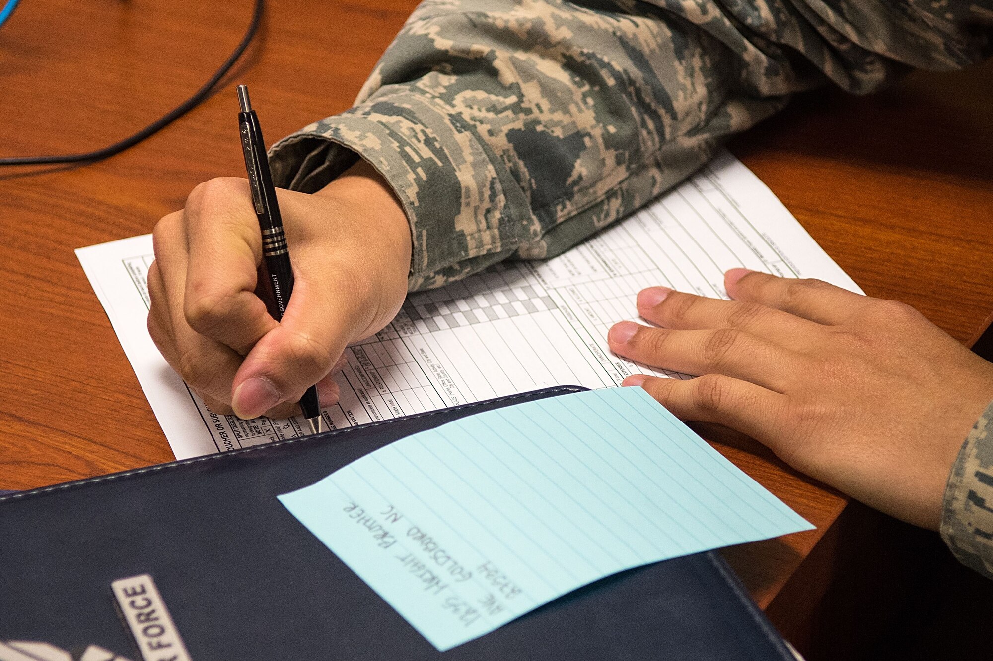 Airman 1st Class Tin Diep, 4th Aircraft Maintenance Squadron avionics technician, fills out a finance form, Jan. 17, 2018, at Seymour Johnson Air Force Base, North Carolina.