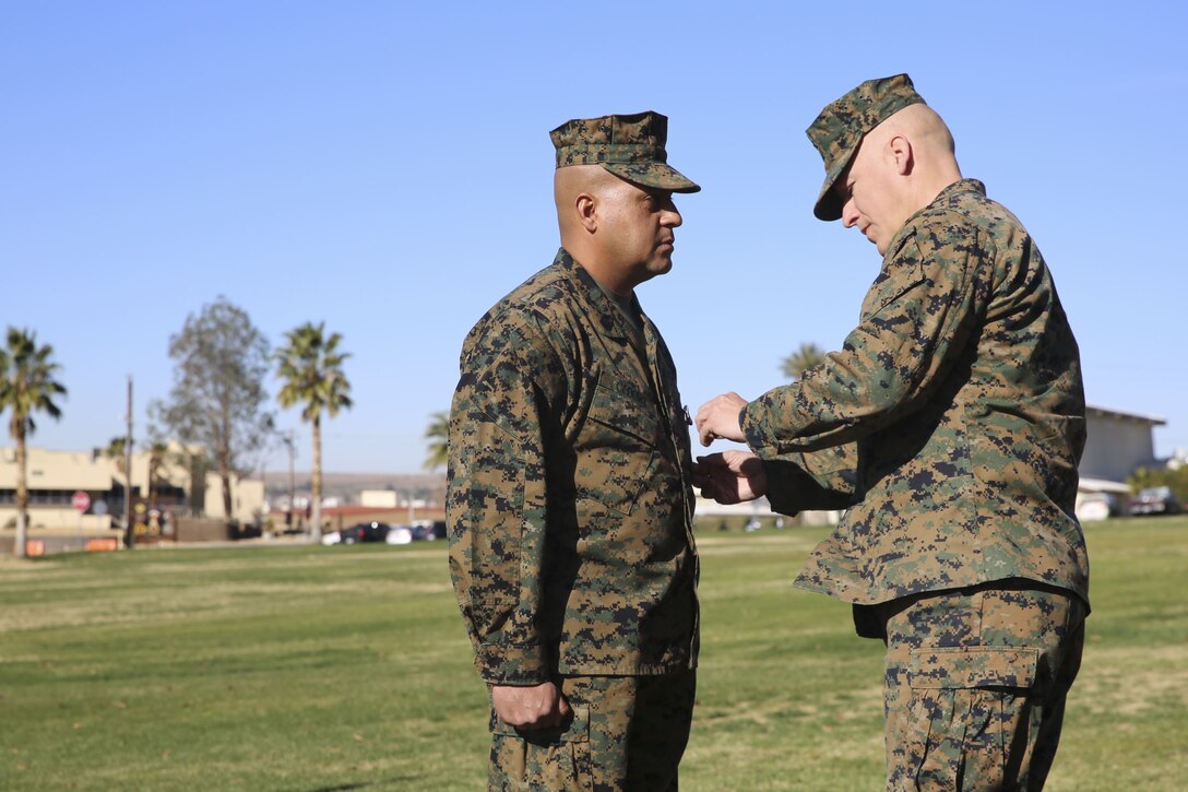 Sgt. Maj. Michael E. Cedeno, off going sergeant major, 1st Battalion, 7th Marine Regiment, Marine Corps Air Ground Combat Center Twentynine Palms, Calif., receives the meritorious service medal for outstanding service for 1/7 during the post and relief ceremony at the commanding general’s lawn aboard the Ground Combat Center Jan. 11, 2018. During the ceremony Cedeno relinquished his post as sergeant major to Sgt. Maj. Brian E. Anderson, incoming sergeant major, 1/7, MCGACC. (Official Marine Corps photo by Lance Cpl. Margaret Gale)