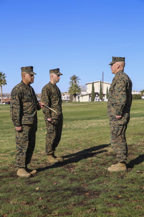 Sgt. Maj. Michael E. Cedeno, off going sergeant major, 1st Battalion, 7th Marine Regiment, Marine Corps Air Ground Combat Center Twentynine Palms, Calif.,  prepares to hand over the Mameluke sword as he relinquishes his post at the commanding general’s lawn aboard the Combat Center Jan. 11, 2018.  During the ceremony Cedeno relinquished his post as sergeant major to Sgt. Maj. Brian E. Anderson, incoming sergeant major, 1/7, MCGACC. (Official Marine Corps photo by Lance Cpl. Margaret Gale)