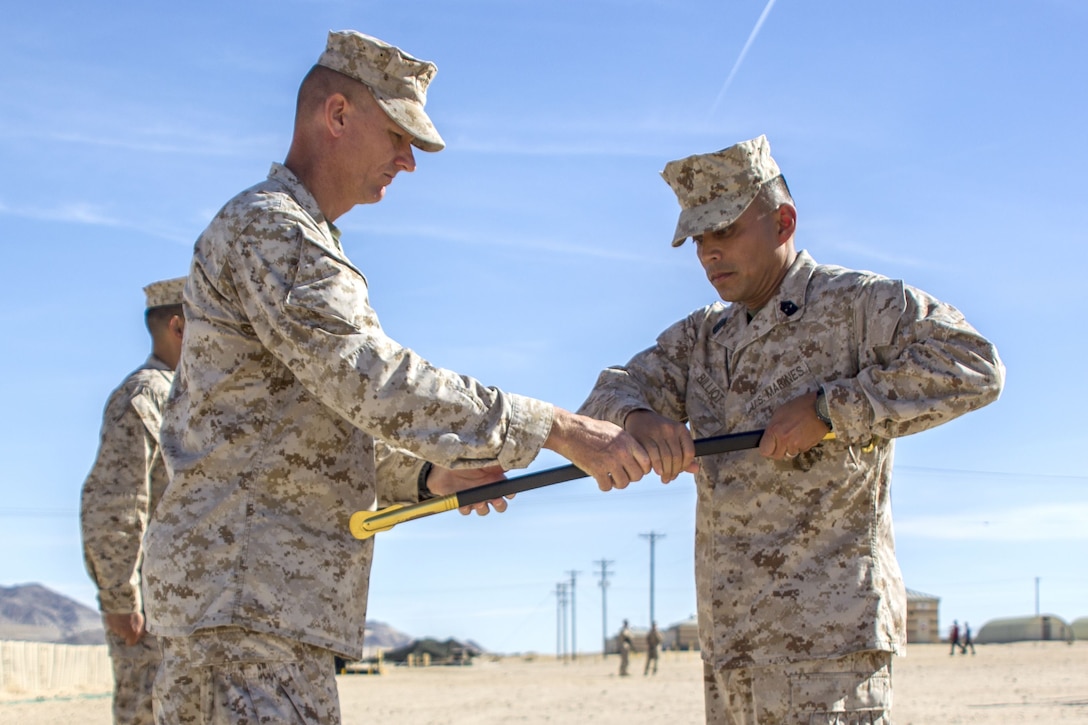 Colonel Michael S. Stskal, Commanding Officer, 3rd Marine Regiment, 3rd Marine Division, hands sword to Sgt Maj. Phillip J. Billiot, 3rd Marine Regiment Sgt. Maj., 3rd Marine Regiment, 3rd Marine Division during post and relief ceremony at Camp Wilson aboard the Marine Corps Air Ground Combat Center, Twentynine Palms, Calif., Jan. 17, 2018. The post and relief ceremony took place during an integrated training exercise that 3rd Marine Division took part in. (U.S. Marine Corps photo by Pfc. Rachel K. Porter)