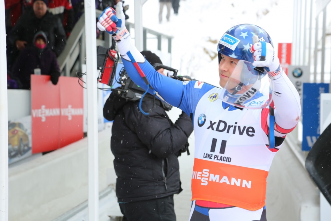 Luge team member acknowledges crowd at 2017 World Cup competition.