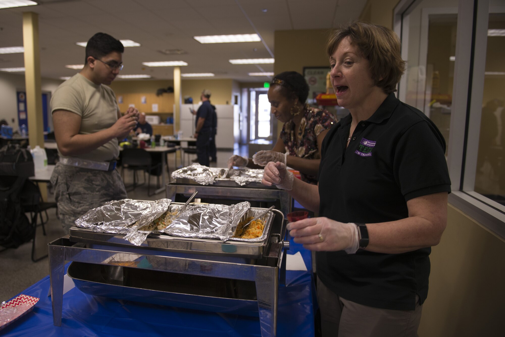 Deb Robinson, 56th Medical Group dietician, serves healthy entree samples as part of a taste test to members of the 62nd Aircraft Maintenance Unit Jan. 18, 2018, at Luke Air Force Base. Robinson, also known as "Diet Deb," is leading an initiative to change food and snack choices at unit snackbars to be healthier and more nutritious without sacrificing flavor. (U.S. Air Force photo/Senior Airman Ridge Shan)