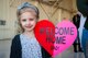 A child poses with her hand made sign for a photo during a redeployment ceremony for the 74th Fighter Squadron, Jan. 19, 2018, at Moody Air Force Base, Ga. Over 300 Airmen from Team Moody deployed for seven months in support of Operation Inherent Resolve to defeat ISIS in designated areas in Iraq and Syria. (U.S. Air Force photo by Andrea Jenkins)