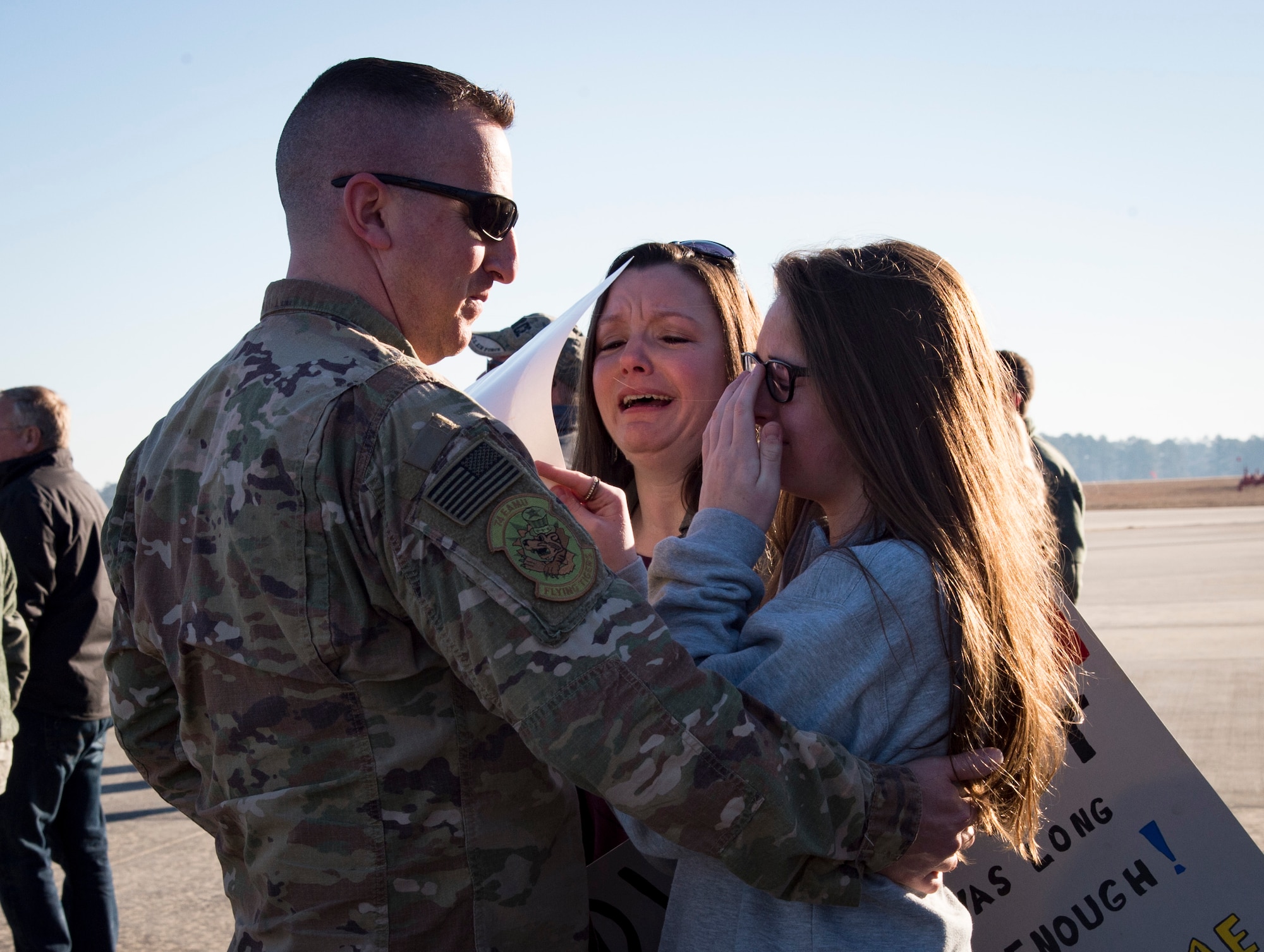 A family shares a moment during a redeployment ceremony for the 74th Fighter Squadron, Jan. 19, 2018, at Moody Air Force Base, Ga. Over 300 Airmen from Team Moody deployed for seven months in support of Operation Inherent Resolve to defeat ISIS in designated areas in Iraq and Syria. (U.S. Air Force photo by Andrea Jenkins)